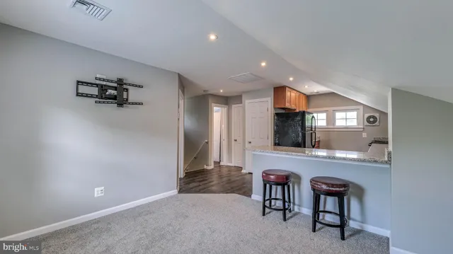 a view of a livingroom with furniture and a flat screen tv