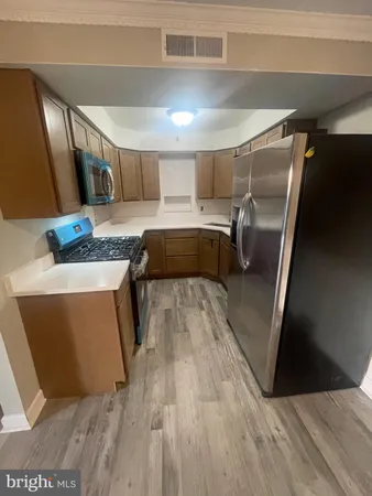 a view of kitchen and wooden floor