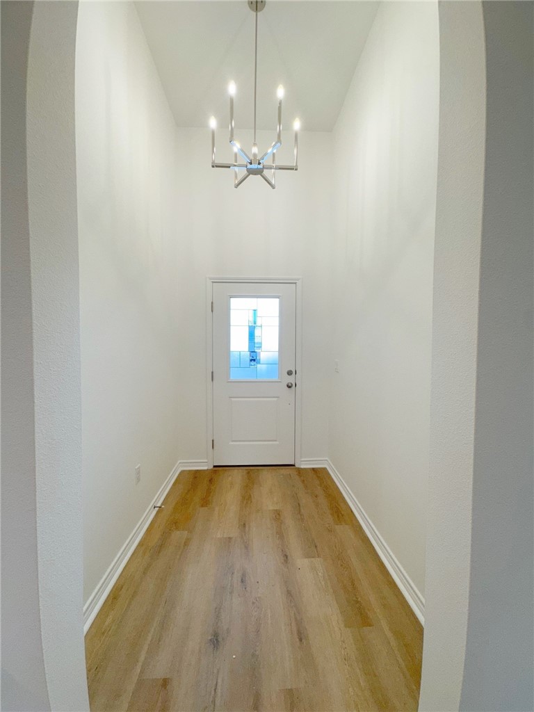 2105 Fury Portland, TX 78374 - Photo 2 of 19 wooden floor in an empty room with a window