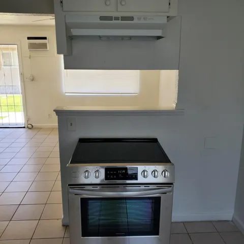 a stove top oven sitting inside of a kitchen