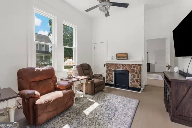 a dining room with wooden floor a chandelier a wooden table and chairs