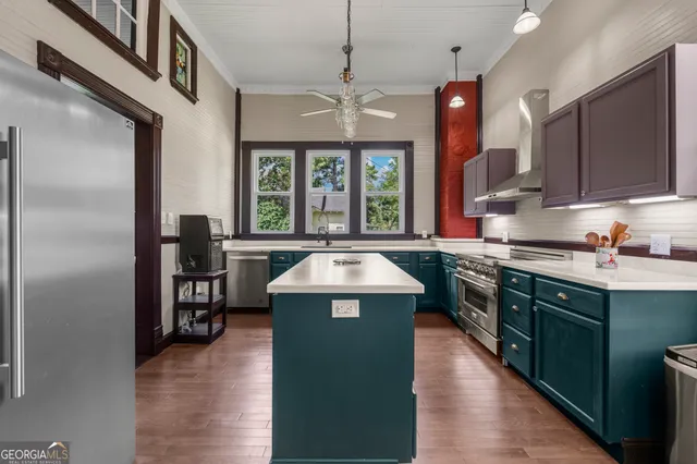 a kitchen with stainless steel appliances wooden cabinets and a stove top oven