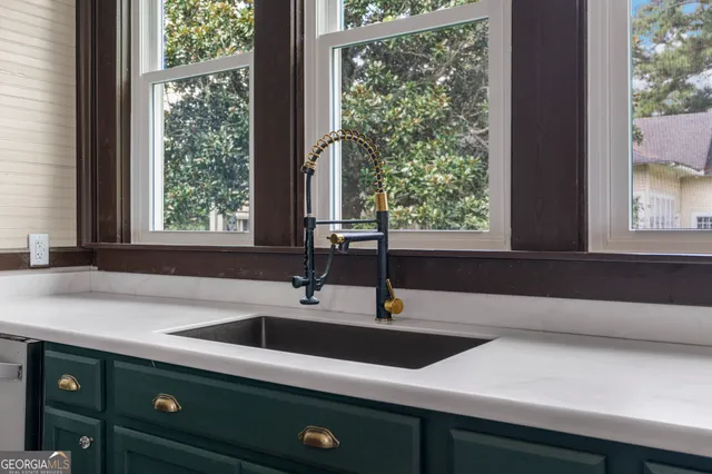 a kitchen with stainless steel appliances granite countertop a sink a stove and a refrigerator