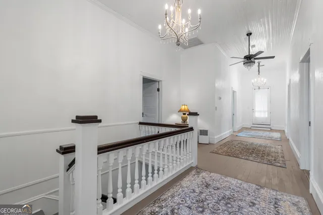 a bedroom with a bed wooden floor and a fireplace