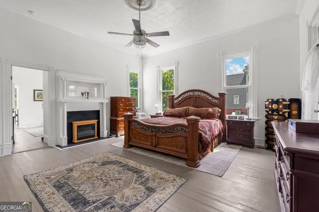 a bathroom with a granite countertop sink a toilet and a mirror