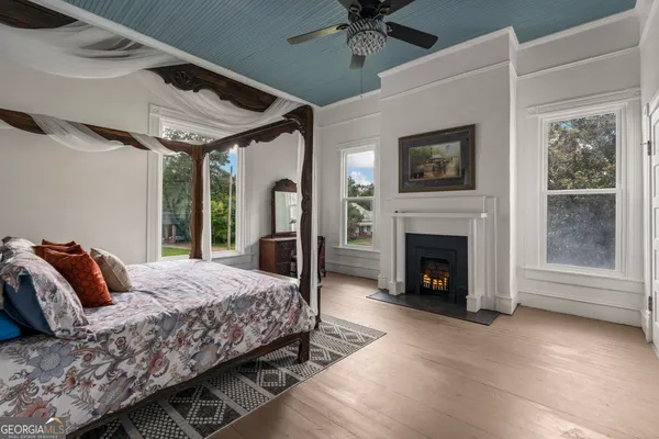 a bed room with furniture and a fireplace