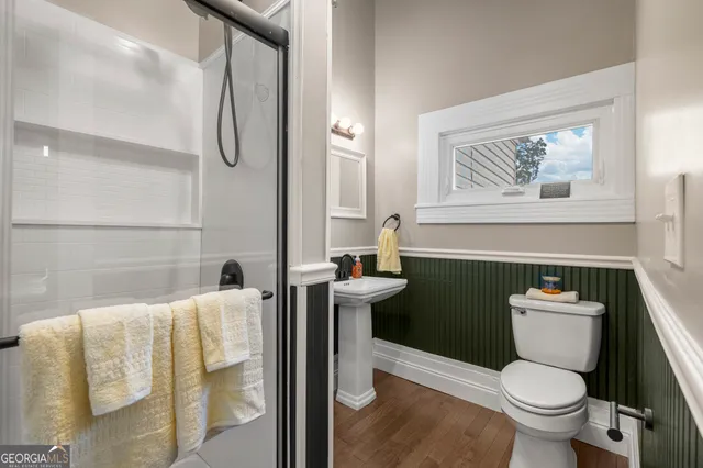 a white toilet sitting next to a bathroom sink