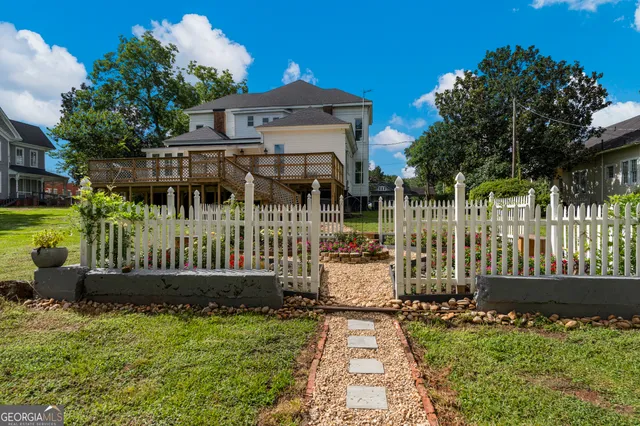 a view of a field with trees in the background