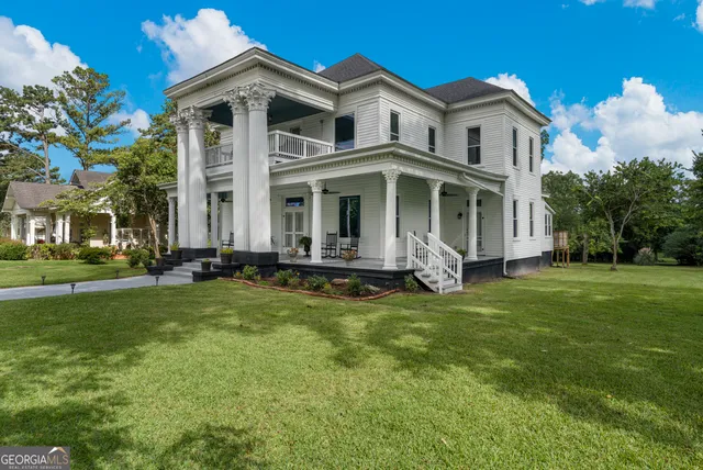 an aerial view of a house with swimming pool garden and patio