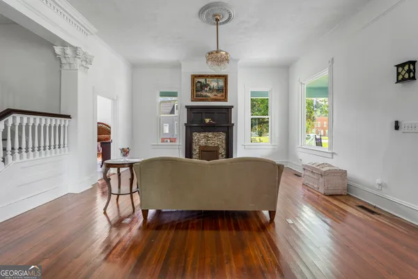 a living room with furniture and a wooden floor