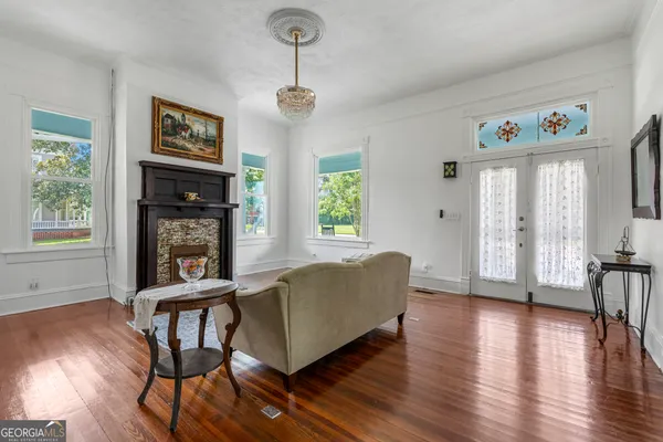 a living room with furniture and wooden floor