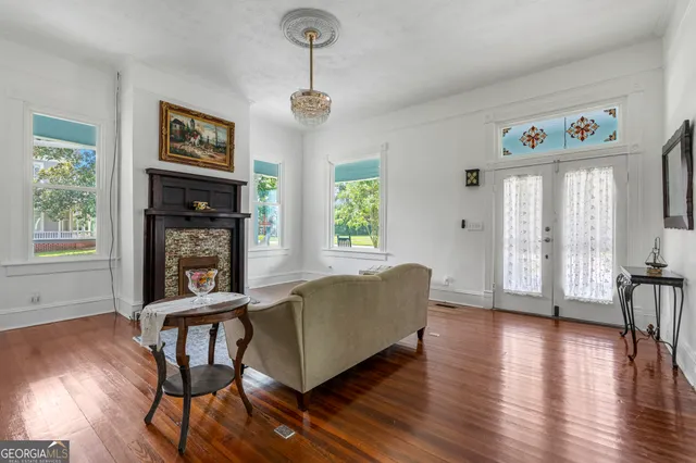 a living room with furniture and wooden floor