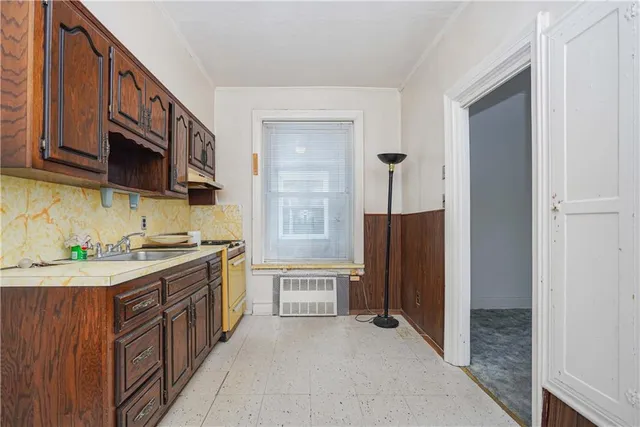 a kitchen with a sink stove and refrigerator