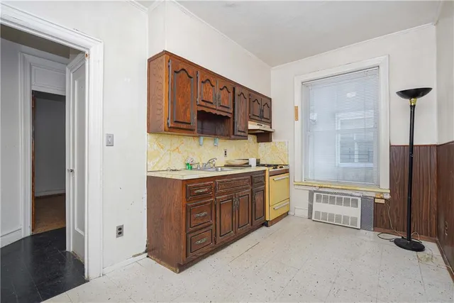 a bathroom with a granite countertop double vanity sink a mirror and a bathtub