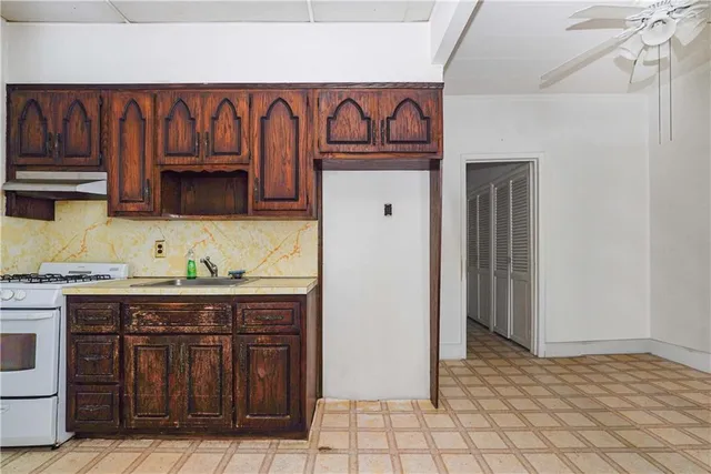 a kitchen with granite countertop a stove and cabinets