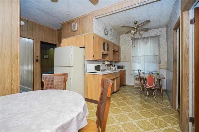 a kitchen with stainless steel appliances a refrigerator sink and cabinets