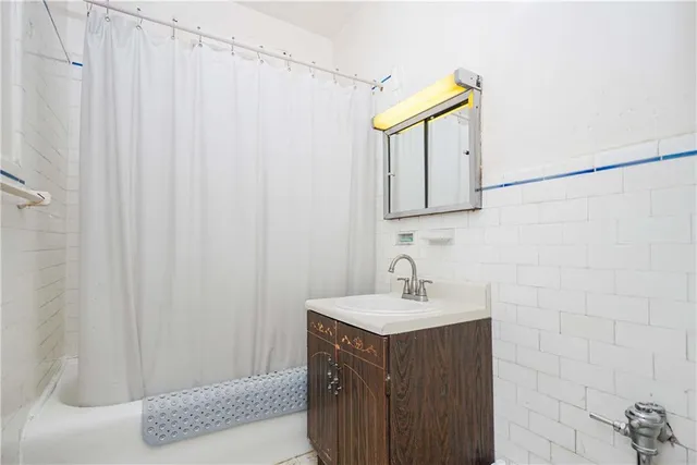 a bathroom with a sink vanity and a mirror