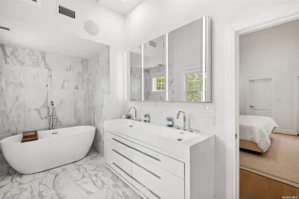 a bathroom with a bathtub and a sink