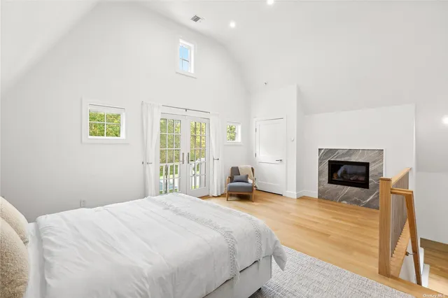 a bedroom with a large bed and a fireplace