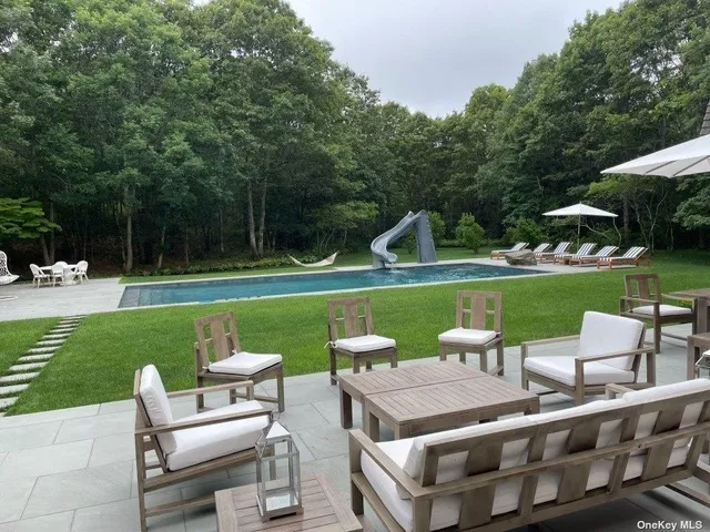 a view of backyard with seating area and green space