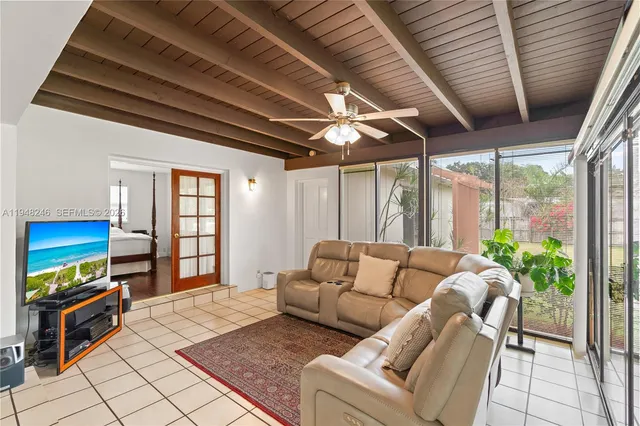 a bedroom with furniture and a large window