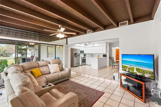 a view of a livingroom with furniture a fireplace and wooden floor