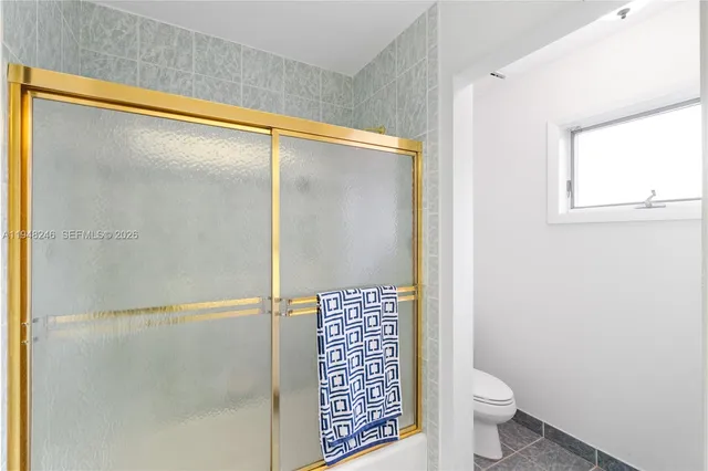 a bathroom with a tub a sink and mirror
