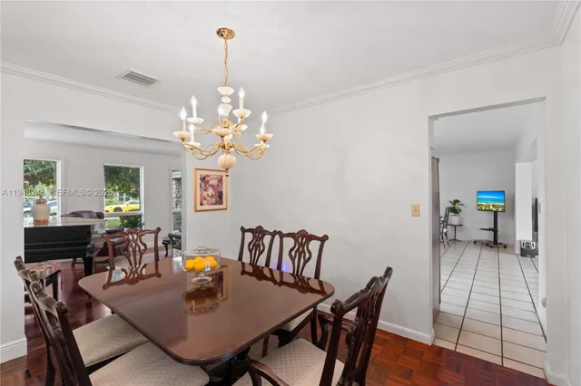 a dining room with furniture and a kitchen view