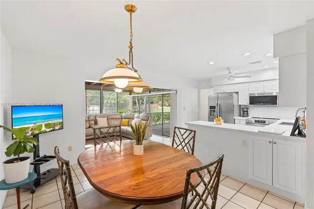 a kitchen with a refrigerator sink and cabinets