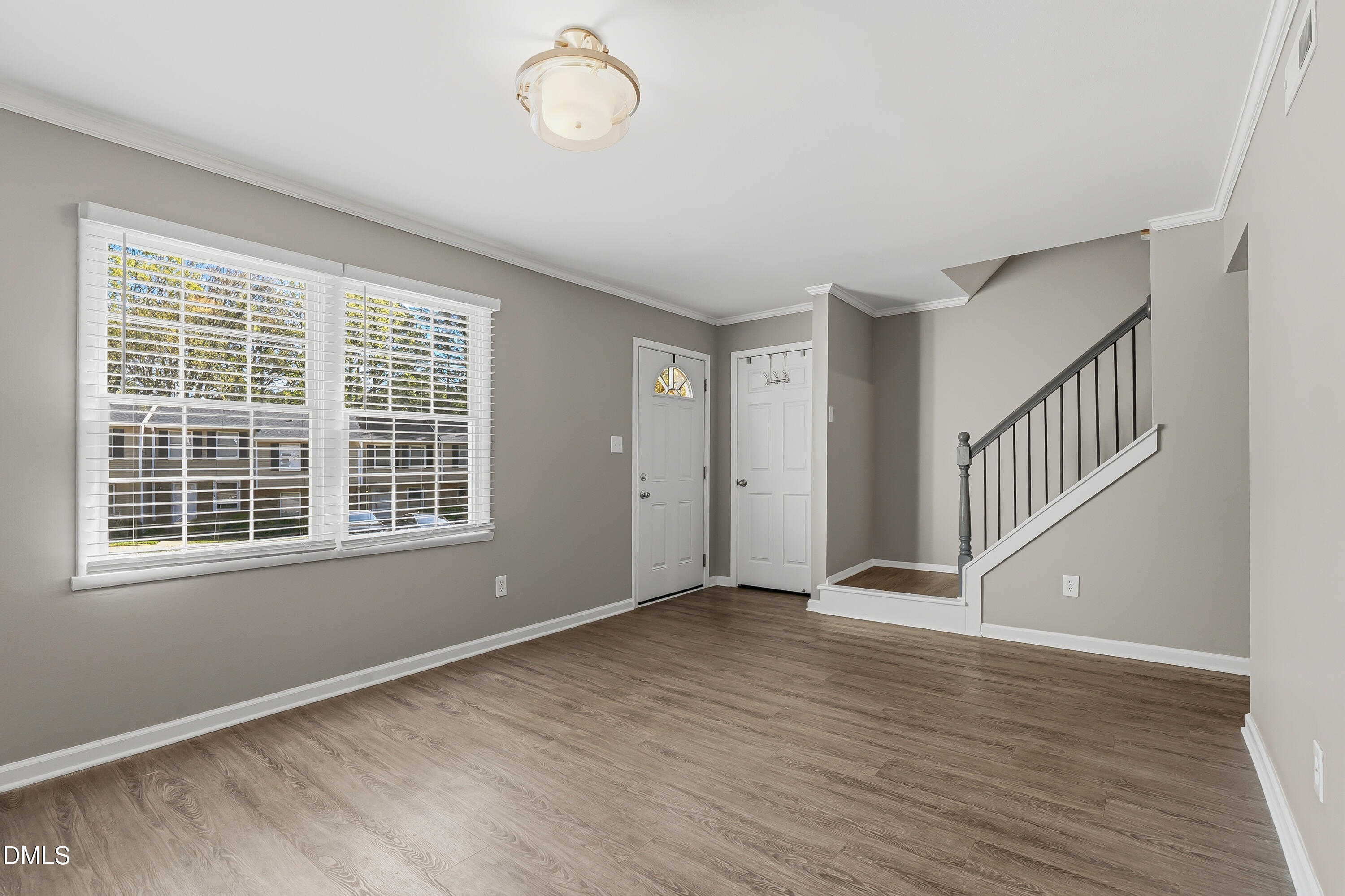 7715 Ohmann Court Raleigh, NC 27615 - Photo 16 of 36 Living Room/Front Door/Stairs