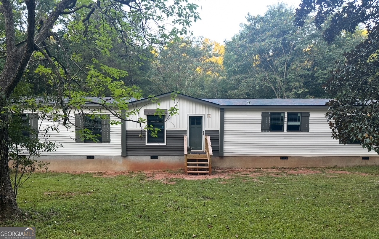 a backyard of a house with table and chairs