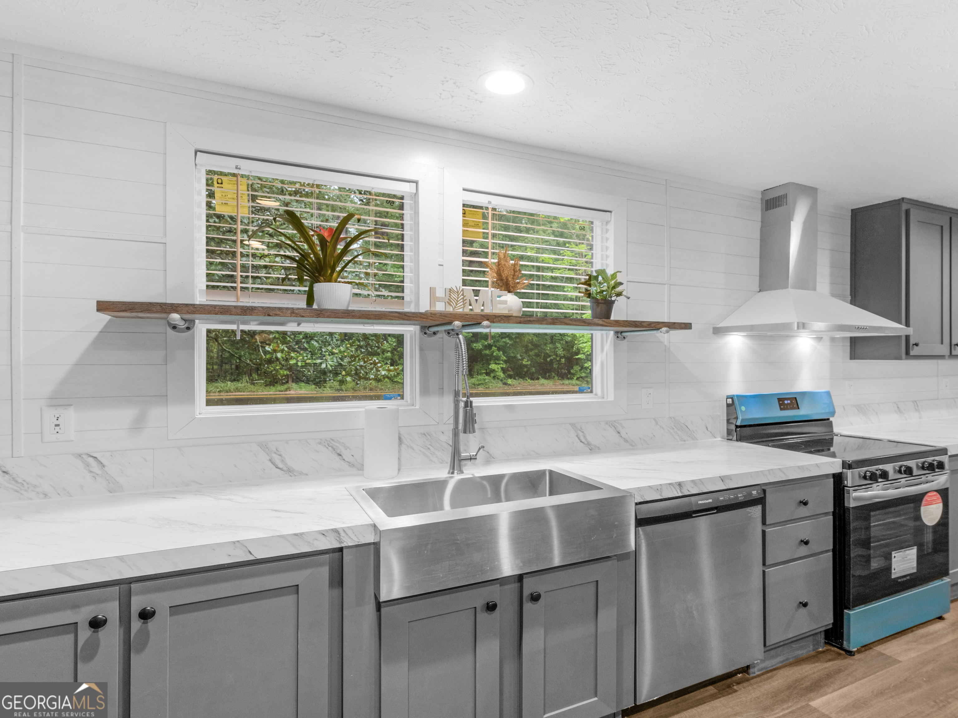 115 Gregory Lane Eatonton, GA 31024 - Photo 11 of 62 a kitchen with stainless steel appliances granite countertop a sink a stove and a window