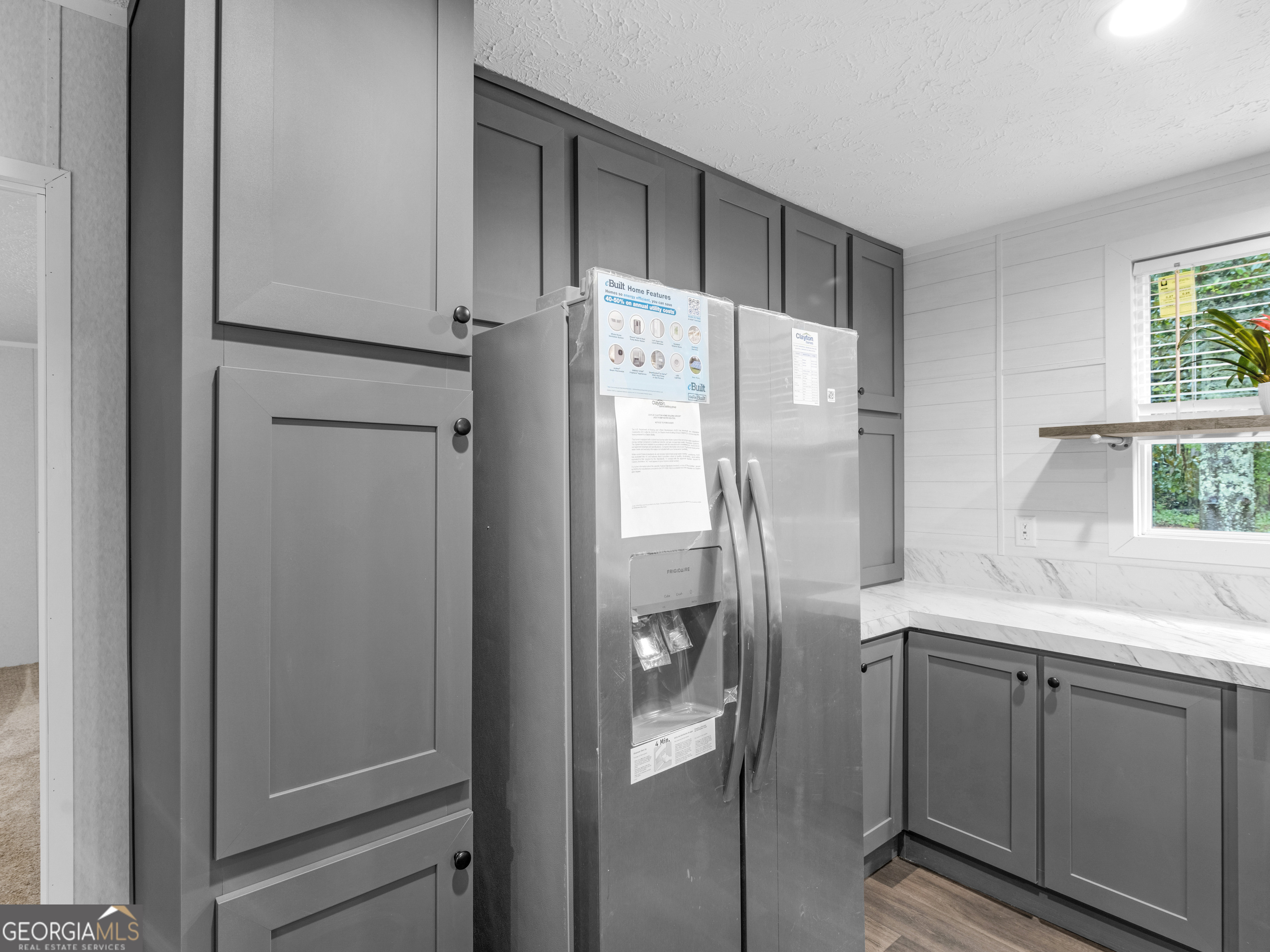 115 Gregory Lane Eatonton, GA 31024 - Photo 12 of 62 a kitchen with a refrigerator and a sink