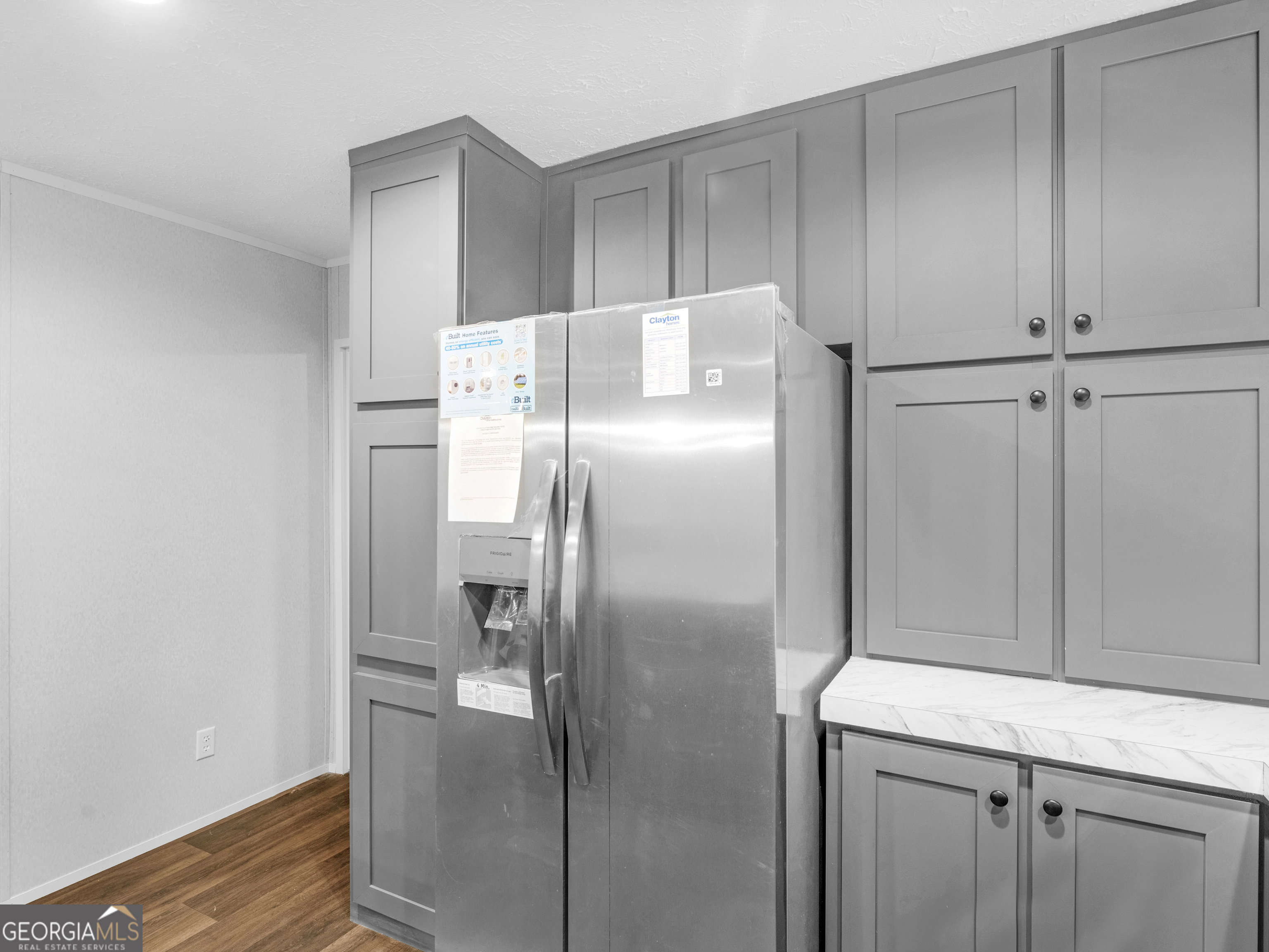 115 Gregory Lane Eatonton, GA 31024 - Photo 13 of 62 a kitchen with metallic refrigerator freezer and a dishwasher