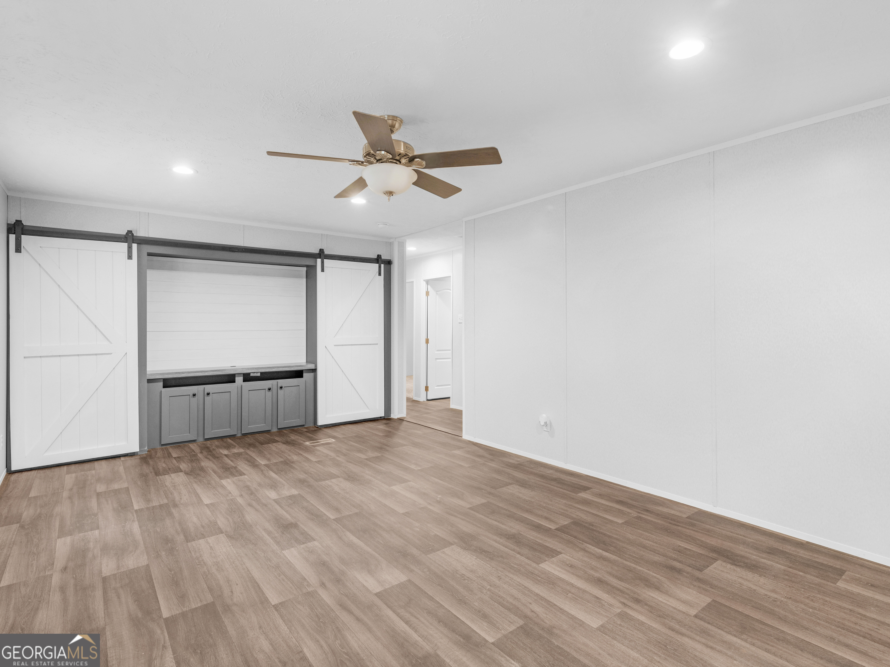 115 Gregory Lane Eatonton, GA 31024 - Photo 22 of 62 a view of empty room with wooden floor and ceiling fan