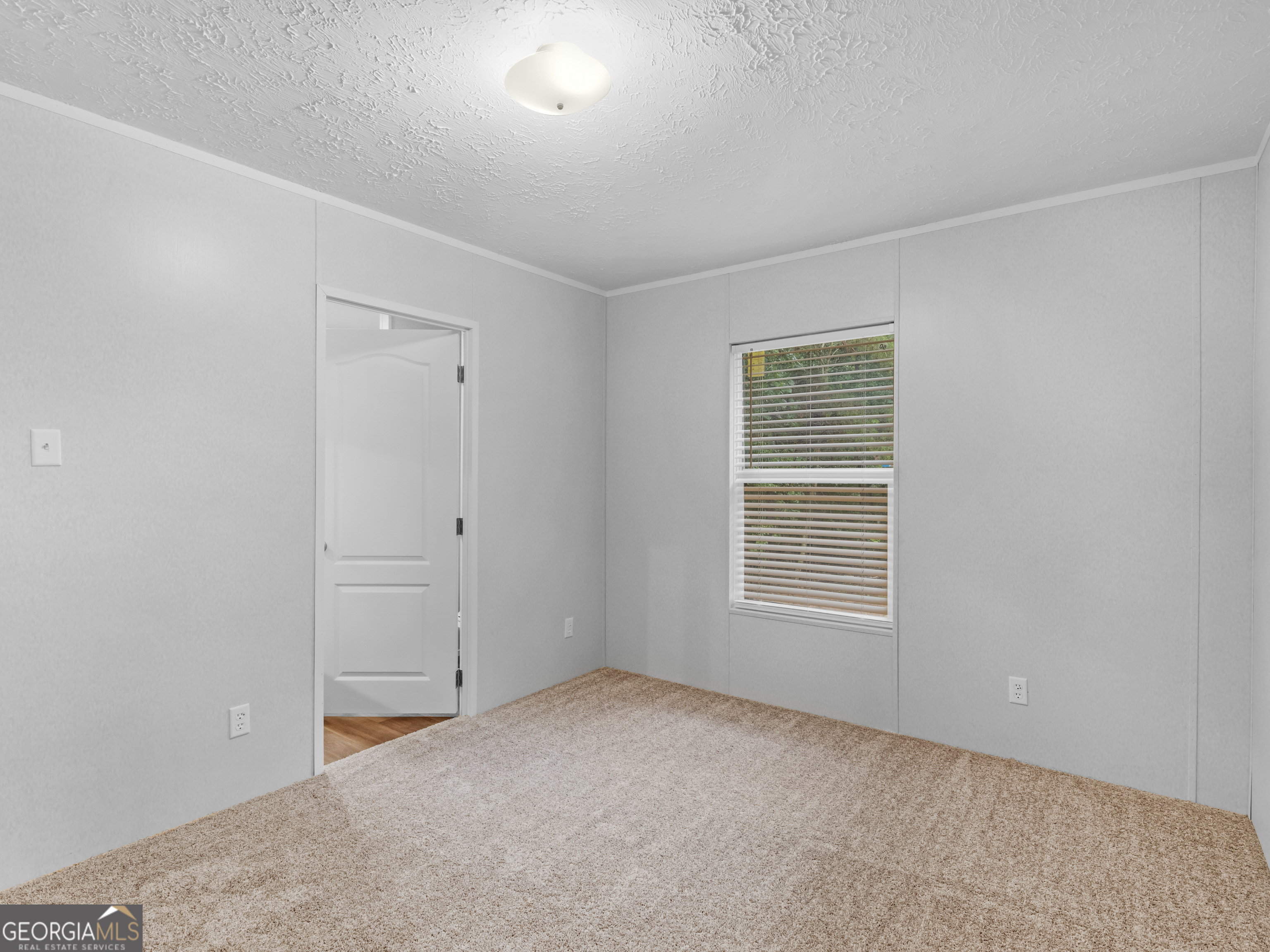 115 Gregory Lane Eatonton, GA 31024 - Photo 27 of 62 a view of an empty room with a window