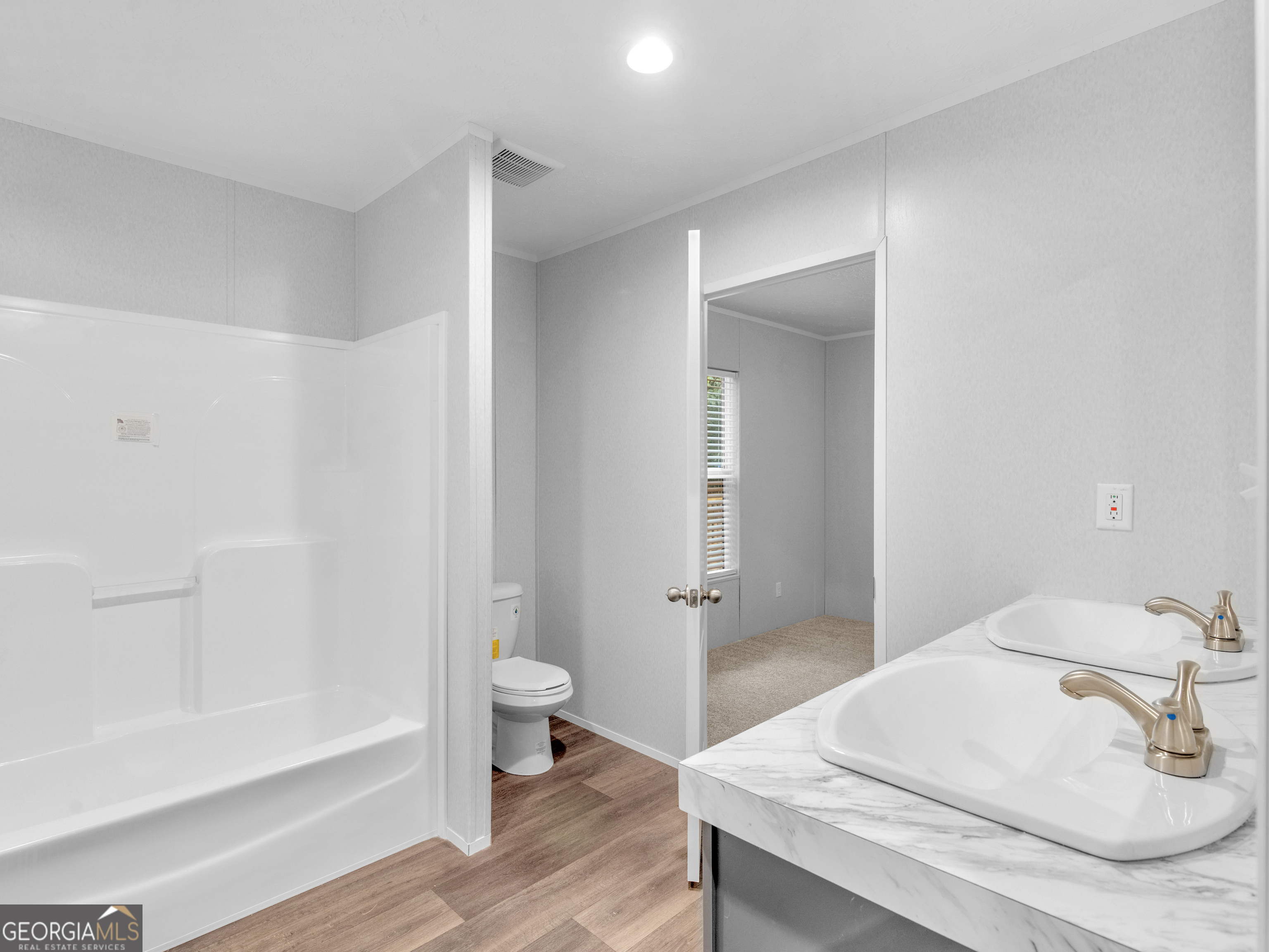 115 Gregory Lane Eatonton, GA 31024 - Photo 33 of 62 a bathroom with a sink a toilet and shower