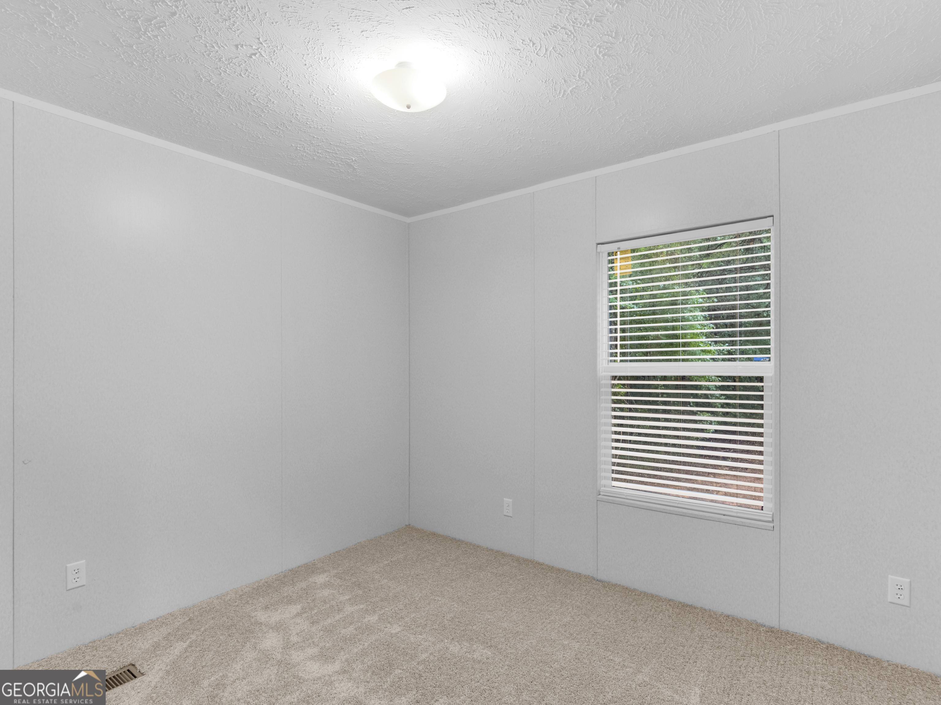 115 Gregory Lane Eatonton, GA 31024 - Photo 34 of 62 an empty room with a window