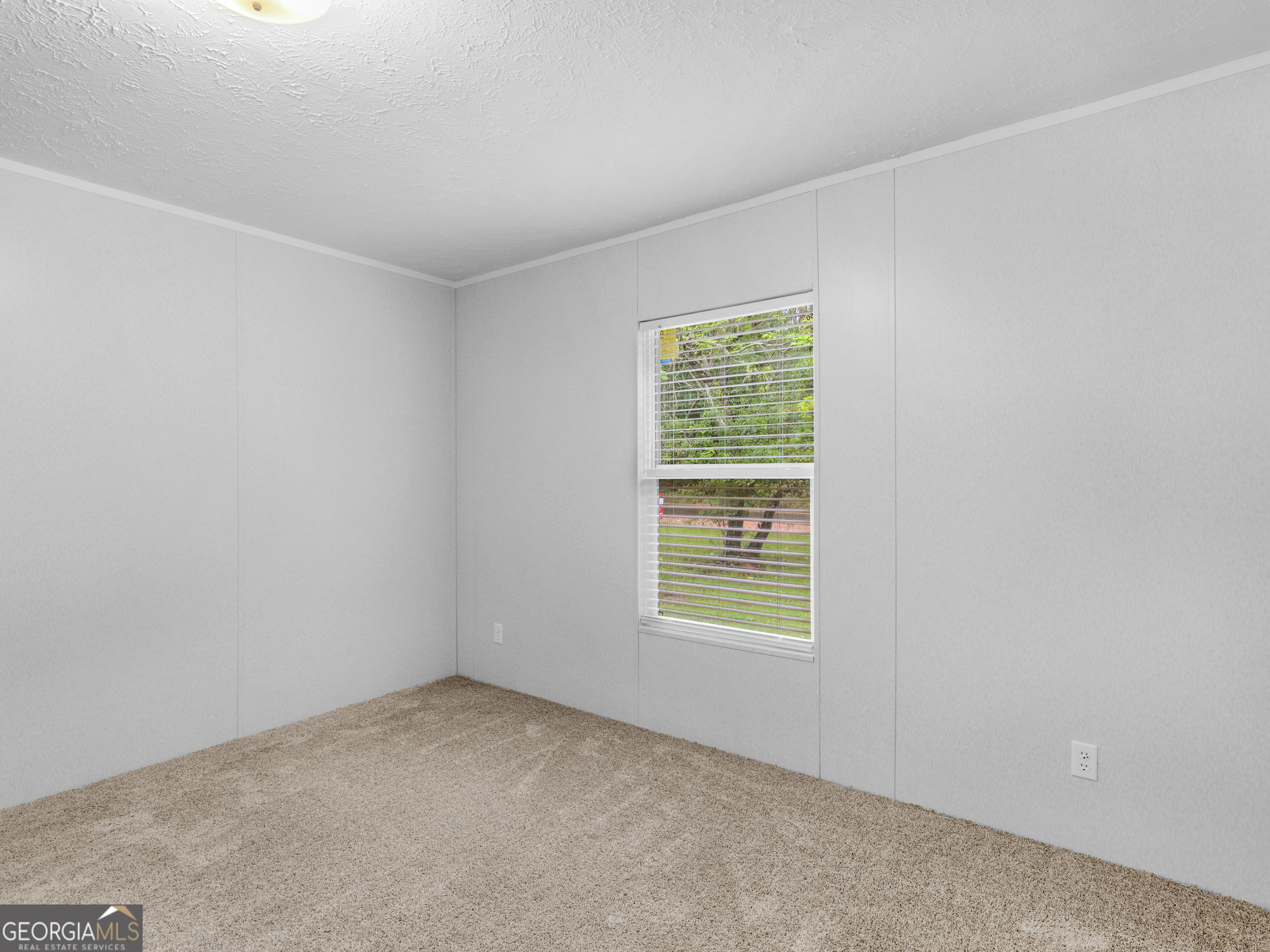 115 Gregory Lane Eatonton, GA 31024 - Photo 39 of 62 an empty room with a window