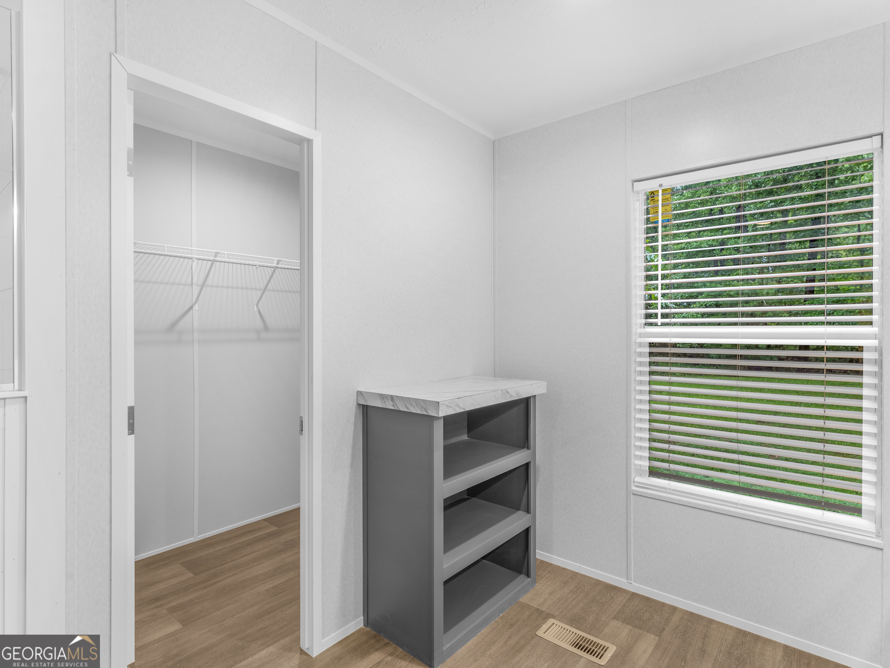 115 Gregory Lane Eatonton, GA 31024 - Photo 47 of 62 a view of walk in closet with empty racks