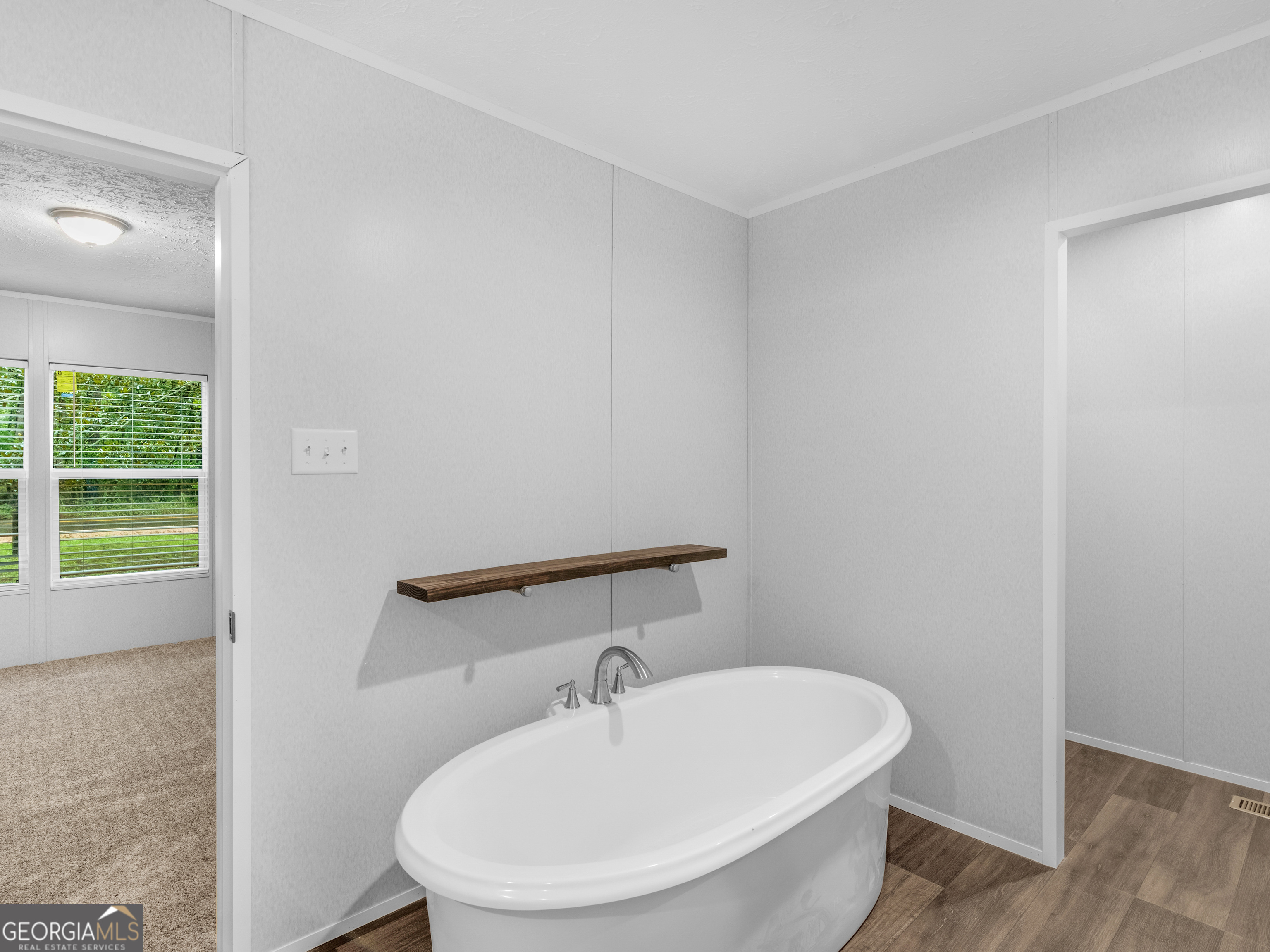 115 Gregory Lane Eatonton, GA 31024 - Photo 50 of 62 a bathroom with a sink a toilet and mirror