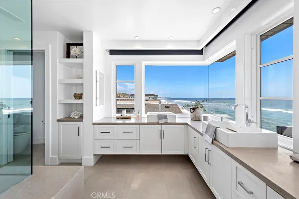 a view of a kitchen with a sink and dishwasher a stove with wooden floor