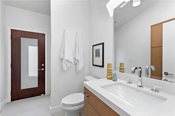 a view of a living room with a sink and wooden floor