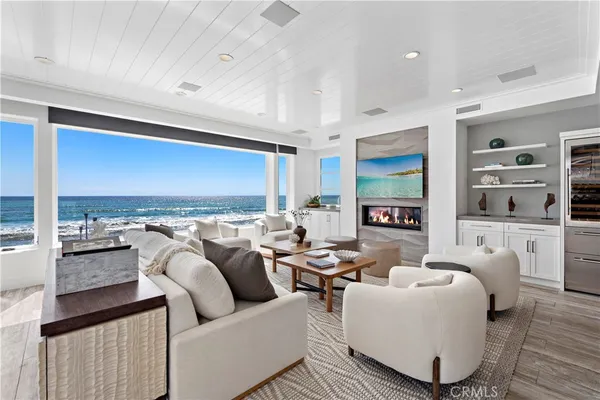 a living room with fireplace furniture and a large window