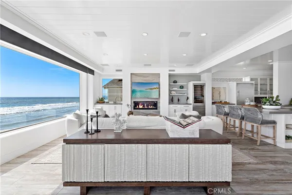 a large white kitchen with a large counter top appliances and cabinets