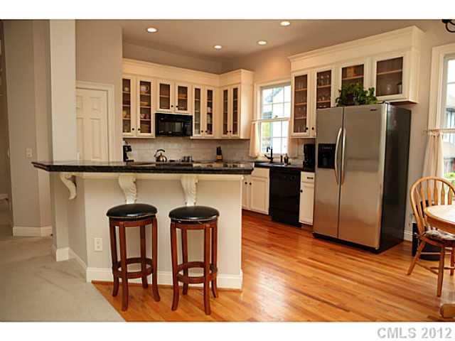 2538 Lower Assembly Drive Fort Mill, SC 29708 - Photo 5 of 16 a kitchen with stainless steel appliances granite countertop a table chairs refrigerator and a sink