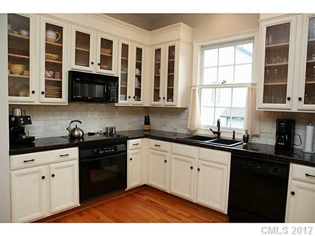2538 Lower Assembly Drive Fort Mill, SC 29708 - Photo 6 of 16 a kitchen with stainless steel appliances granite countertop a stove a sink dishwasher and cabinets with wooden floor