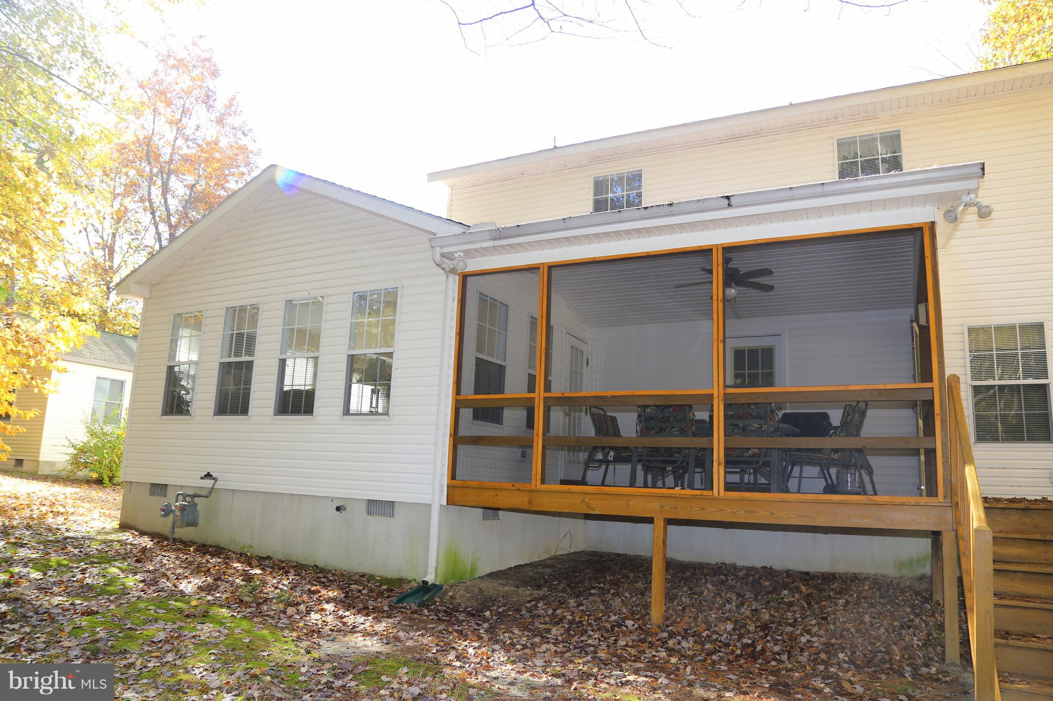 43 Falcon Bridge Road Ocean Pines, MD 21811 - Photo 11 of 30 a view of a house with a window and wooden fence