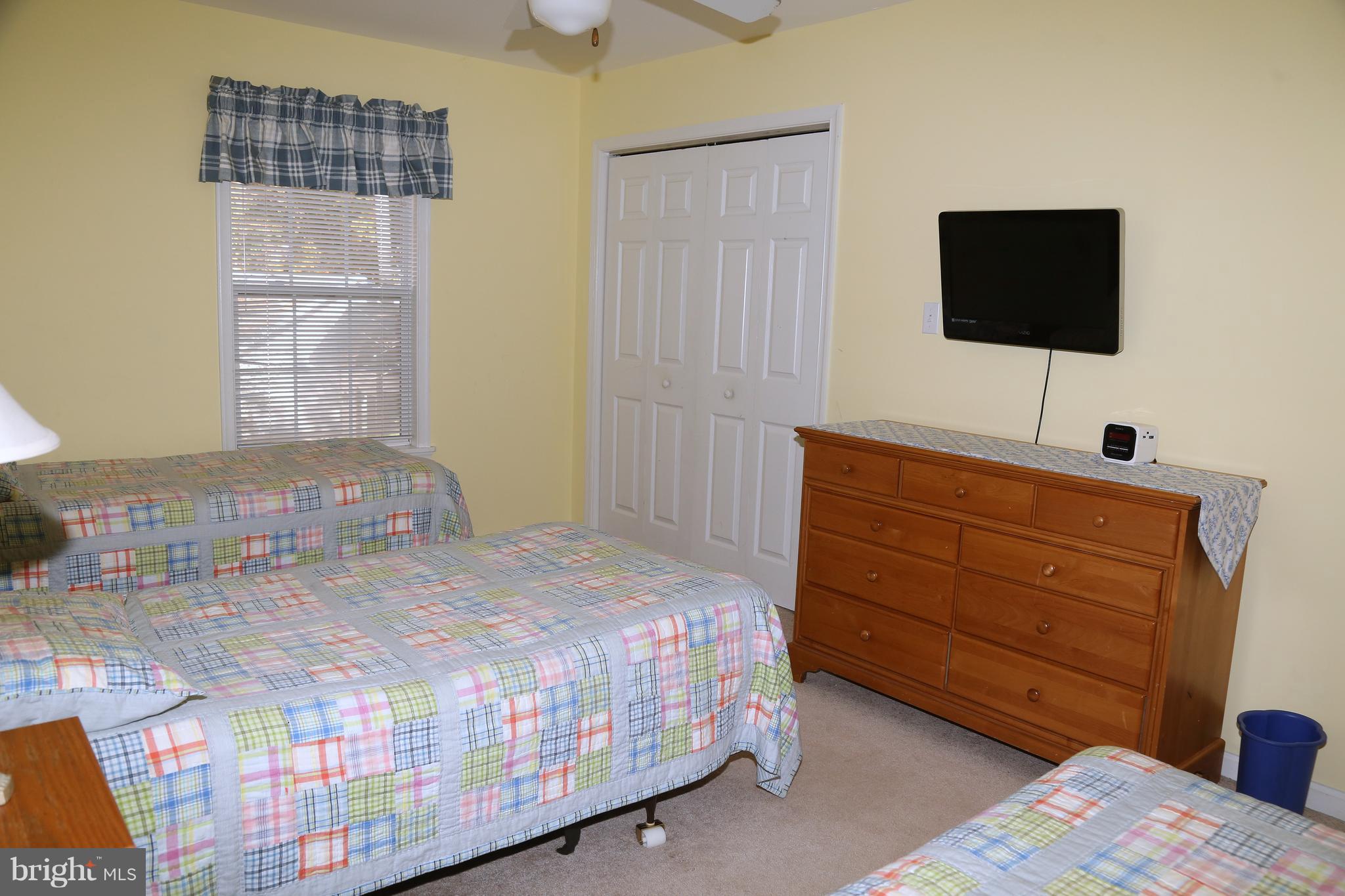 43 Falcon Bridge Road Ocean Pines, MD 21811 - Photo 24 of 30 a bedroom with a bed and a flat tv screen on dresser