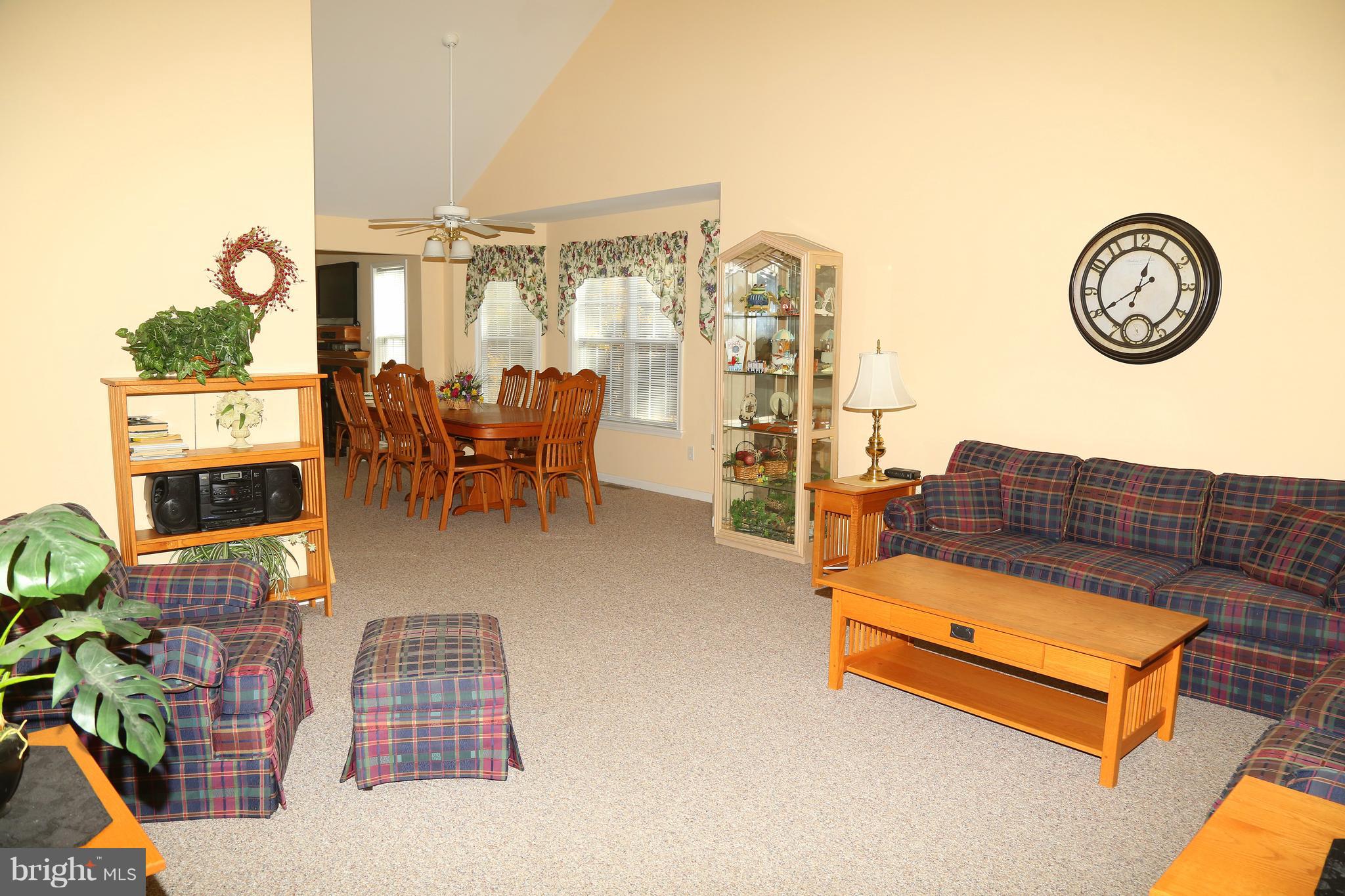 43 Falcon Bridge Road Ocean Pines, MD 21811 - Photo 3 of 30 a living room with furniture a clock on wall and a table